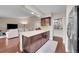 Open kitchen featuring a center island, modern cabinets, and a view into the adjacent living room at 3450 W Amherst Ave, Denver, CO 80236