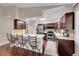 Modern kitchen features stainless appliances, dark wood cabinets, and a breakfast bar with seating for four at 3450 W Amherst Ave, Denver, CO 80236