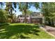 Expansive backyard featuring a well-maintained lawn, mature trees, and an outdoor seating area at 400 Holly St, Denver, CO 80220