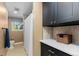 Cozy bathroom featuring black cabinets, a shower with a white curtain, and a view to the outside at 400 Holly St, Denver, CO 80220