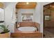 Stunning bathroom featuring a round soaking tub with tile surround and a walk-in shower with glass door at 400 Holly St, Denver, CO 80220