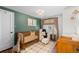 Charming Bedroom with a wooden crib, cozy chair, and stylish decor for a comfortable and inviting space at 400 Holly St, Denver, CO 80220