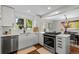 Bright, remodeled kitchen featuring white cabinets, stainless steel appliances and hardwood floors at 400 Holly St, Denver, CO 80220