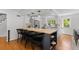 Open kitchen design with island seating, modern lighting, hardwood floors and stainless appliances at 400 Holly St, Denver, CO 80220