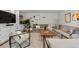 Spacious living room with a large sectional sofa, built-in cabinets, and stylish decor for a comfortable gathering space at 400 Holly St, Denver, CO 80220