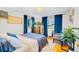 Relaxing bedroom featuring a comfortable bed, bright windows, and a cozy sitting area with plants at 4145 Dudley St, Wheat Ridge, CO 80033