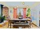 Cozy dining room with modern light fixture, tiled floor, and wood burning stove at 4145 Dudley St, Wheat Ridge, CO 80033