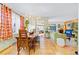 Charming dining room with modern lighting, wood furniture, and an open view to the living area at 4145 Dudley St, Wheat Ridge, CO 80033