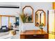 Entryway area with wooden furniture, mirror decor, and open access to an interior living space at 4145 Dudley St, Wheat Ridge, CO 80033