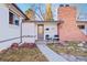 Inviting front entrance with a charming door, brick chimney, and cozy seating area, perfect for greeting guests at 4145 Dudley St, Wheat Ridge, CO 80033