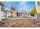 Inviting front yard features chairs, a small table, a brick chimney, and a walkway leading to the home's entrance at 4145 Dudley St, Wheat Ridge, CO 80033