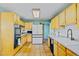 Spacious kitchen with abundant cabinet space, stainless appliances, and tiled floor at 4145 Dudley St, Wheat Ridge, CO 80033