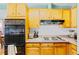 Cozy kitchen featuring vintage appliances and classic cabinetry at 4145 Dudley St, Wheat Ridge, CO 80033