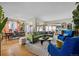 Spacious living room with dining area featuring stylish seating, open layout, and abundant natural light at 4145 Dudley St, Wheat Ridge, CO 80033