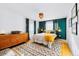 Stylish main bedroom features wood floors, area rug, and designer accents at 4145 Dudley St, Wheat Ridge, CO 80033