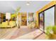 Bright sun room leading into a contemporary living space, featuring an array of plants at 4145 Dudley St, Wheat Ridge, CO 80033
