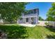 Well-maintained backyard with patio, grass, garden beds and partial privacy fence at 4830 Monarch Dr, Firestone, CO 80504