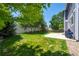 A lush backyard features a manicured lawn, a patio, and a privacy fence at 4830 Monarch Dr, Firestone, CO 80504