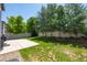 A spacious backyard with a patio, lush grass, and a white privacy fence at 4830 Monarch Dr, Firestone, CO 80504