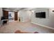 Open basement area featuring a cozy fireplace, TV, and barn door leading to a bedroom at 4830 Monarch Dr, Firestone, CO 80504