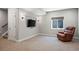 Finished basement with comfy chair, a window, mounted television, and carpeted floor at 4830 Monarch Dr, Firestone, CO 80504