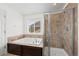Bright bathroom featuring soaking tub and shower with glass door and tile surround at 4830 Monarch Dr, Firestone, CO 80504