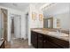 Bathroom with double sink vanity featuring granite counters, tile floor, and framed wall art at 4830 Monarch Dr, Firestone, CO 80504
