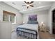 Cozy bedroom features a queen bed, mountain art, and window with woven shades at 4830 Monarch Dr, Firestone, CO 80504