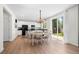 Modern kitchen with stainless steel appliances, white cabinetry, and a dining area overlooking a well-maintained backyard at 4830 Monarch Dr, Firestone, CO 80504