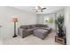 Comfortable living area showcasing a large gray sectional with ottoman, lamp, and a large window at 4830 Monarch Dr, Firestone, CO 80504