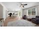 Open living space with a view of the kitchen, dining area, and backyard through sliding glass doors at 4830 Monarch Dr, Firestone, CO 80504