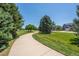A scenic walking path surrounded by lush greenery and beautiful trees at 4830 Monarch Dr, Firestone, CO 80504