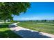 A beautiful walking path lined with trees leads to a vast open field at 4830 Monarch Dr, Firestone, CO 80504