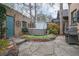 Serene backyard featuring a hot tub, custom patio, landscaped garden, and grill at 3701 Eliot St, Denver, CO 80211