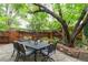 A relaxing outdoor patio with stone flooring, a dining table and beautiful trees at 3701 Eliot St, Denver, CO 80211
