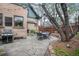 Beautiful backyard patio with stone flooring, mature trees, grill and dining area great for entertaining at 3701 Eliot St, Denver, CO 80211
