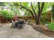 Charming backyard patio featuring stone pavers, mature trees, ambient lighting and comfortable seating at 3701 Eliot St, Denver, CO 80211