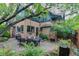 A beautiful outdoor patio with a dining table, grill, lush landscaping and a charming exterior at 3701 Eliot St, Denver, CO 80211