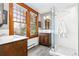 Bathroom showcasing natural light from large windows, dual sinks, and a glass-enclosed shower at 3701 Eliot St, Denver, CO 80211