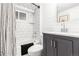 Modern bathroom boasts subway tile, a shower-tub combo, and contemporary fixtures at 3701 Eliot St, Denver, CO 80211