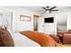 Large bedroom featuring modern fan, en suite bathroom, and hardwood flooring at 3701 Eliot St, Denver, CO 80211