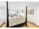 Comfortable bedroom with a canopy bed, soft lighting, and bright walls at 3701 Eliot St, Denver, CO 80211