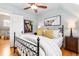 Charming bedroom with black metal bed frame, skylight, stylish art and decor at 3701 Eliot St, Denver, CO 80211