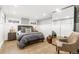 Cozy bedroom with a platform bed, ample natural light, and a stylish full-length mirror at 3701 Eliot St, Denver, CO 80211