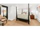 Relaxing bedroom with a canopy bed, plush bedding, and a large mirror at 3701 Eliot St, Denver, CO 80211