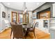 Bright dining room with built-in cabinets, stylish lighting, and hardwood floors at 3701 Eliot St, Denver, CO 80211