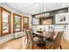 Elegant dining room with hardwood floors, stylish lighting, and large windows at 3701 Eliot St, Denver, CO 80211