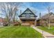 Stunning two-story home featuring a lush lawn and inviting front porch at 3701 Eliot St, Denver, CO 80211