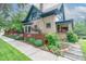 Charming two-story home with a brick exterior, landscaped yard and inviting covered porch at 3701 Eliot St, Denver, CO 80211