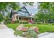 Charming two-story brick home with a beautifully landscaped front yard and inviting front porch at 3701 Eliot St, Denver, CO 80211